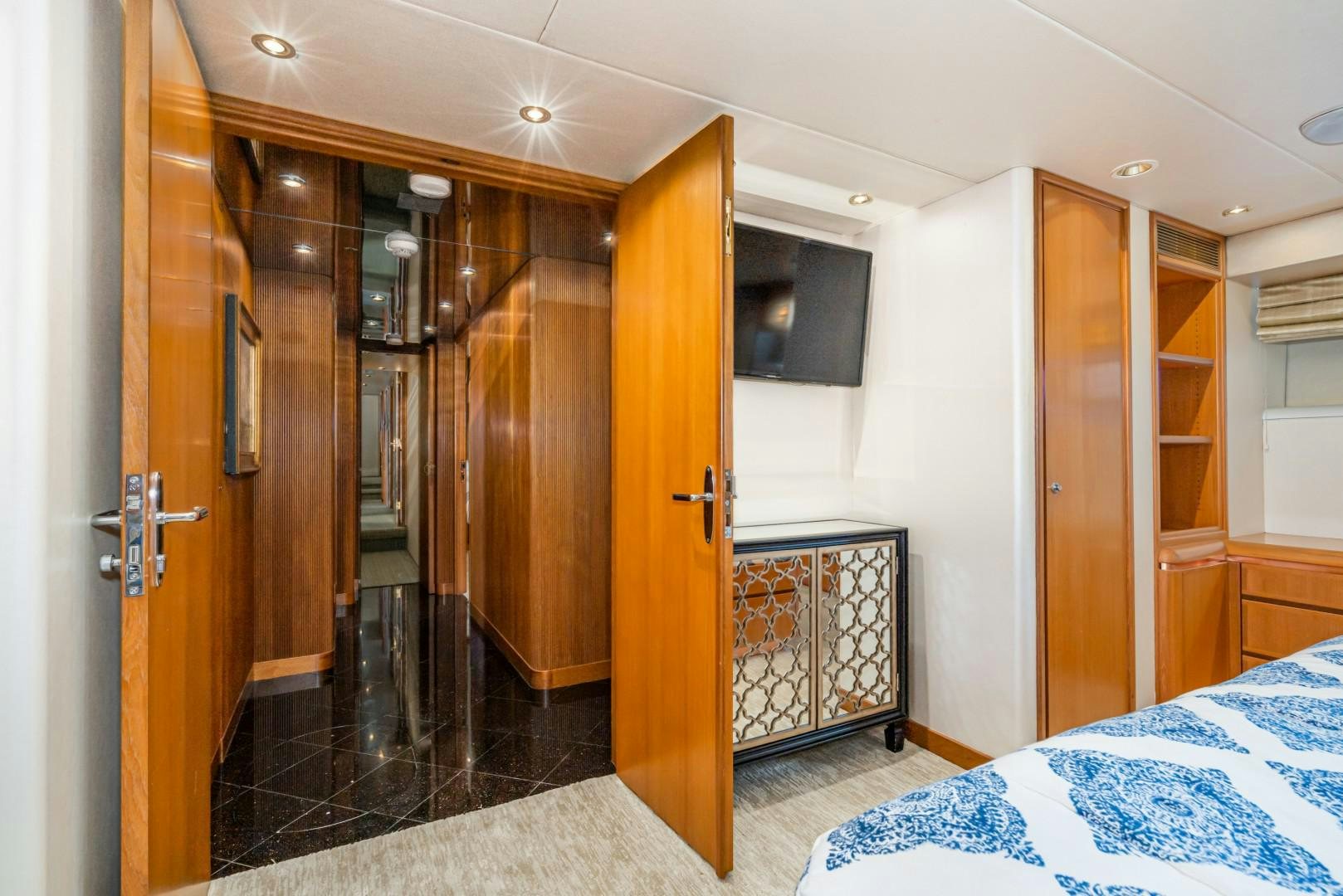 a bedroom with a bed and a closet aboard AFTERGLOW Yacht for Sale