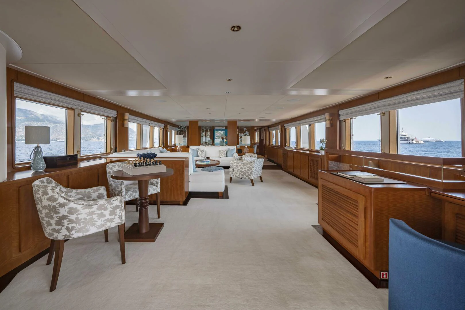 a large room with a table and chairs aboard SYNTHESIS 66 Yacht for Sale