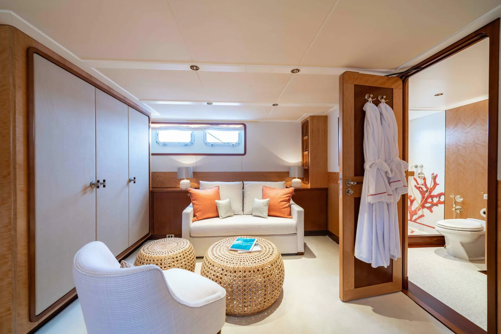 a bathroom with a white couch and a large mirror aboard SYNTHESIS 66 Yacht for Sale