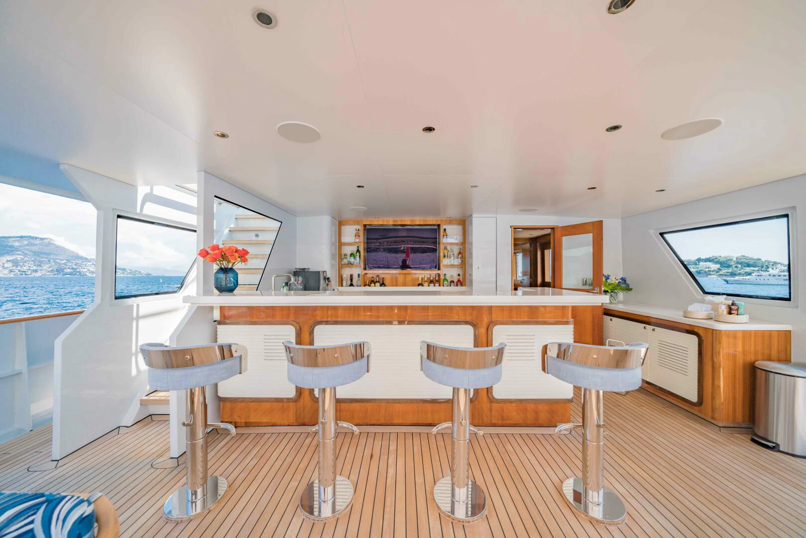 a kitchen with stools and stools aboard SYNTHESIS 66 Yacht for Sale