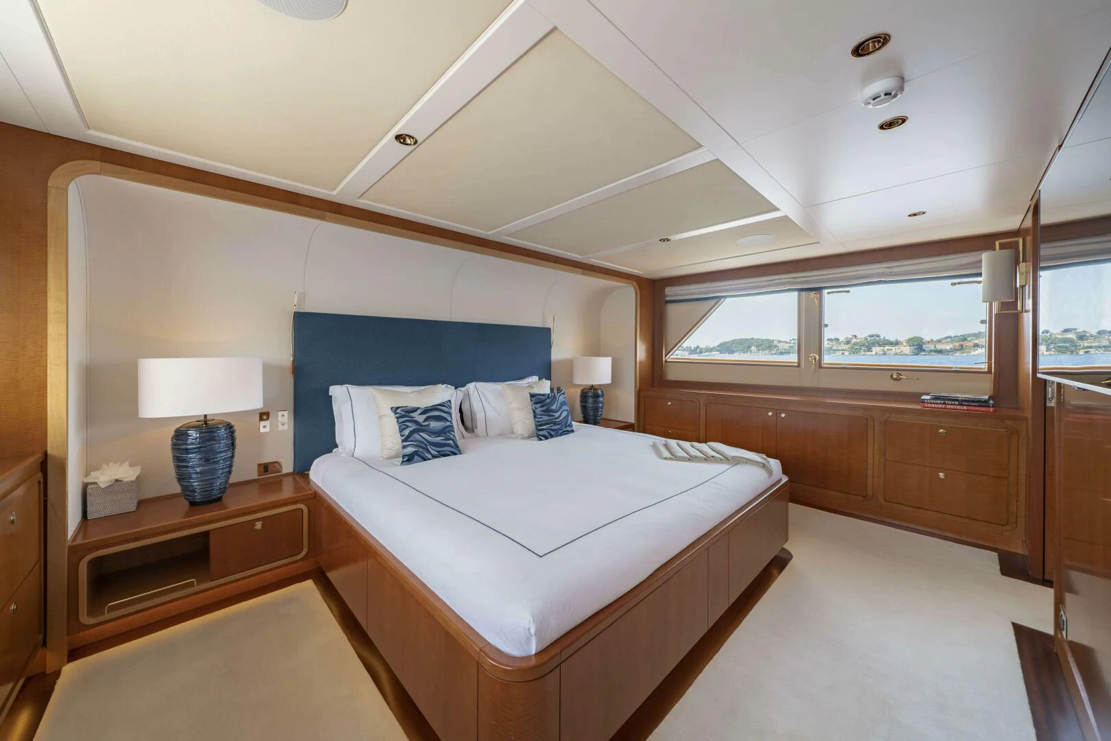 a bedroom with a bed and a desk aboard SYNTHESIS 66 Yacht for Sale