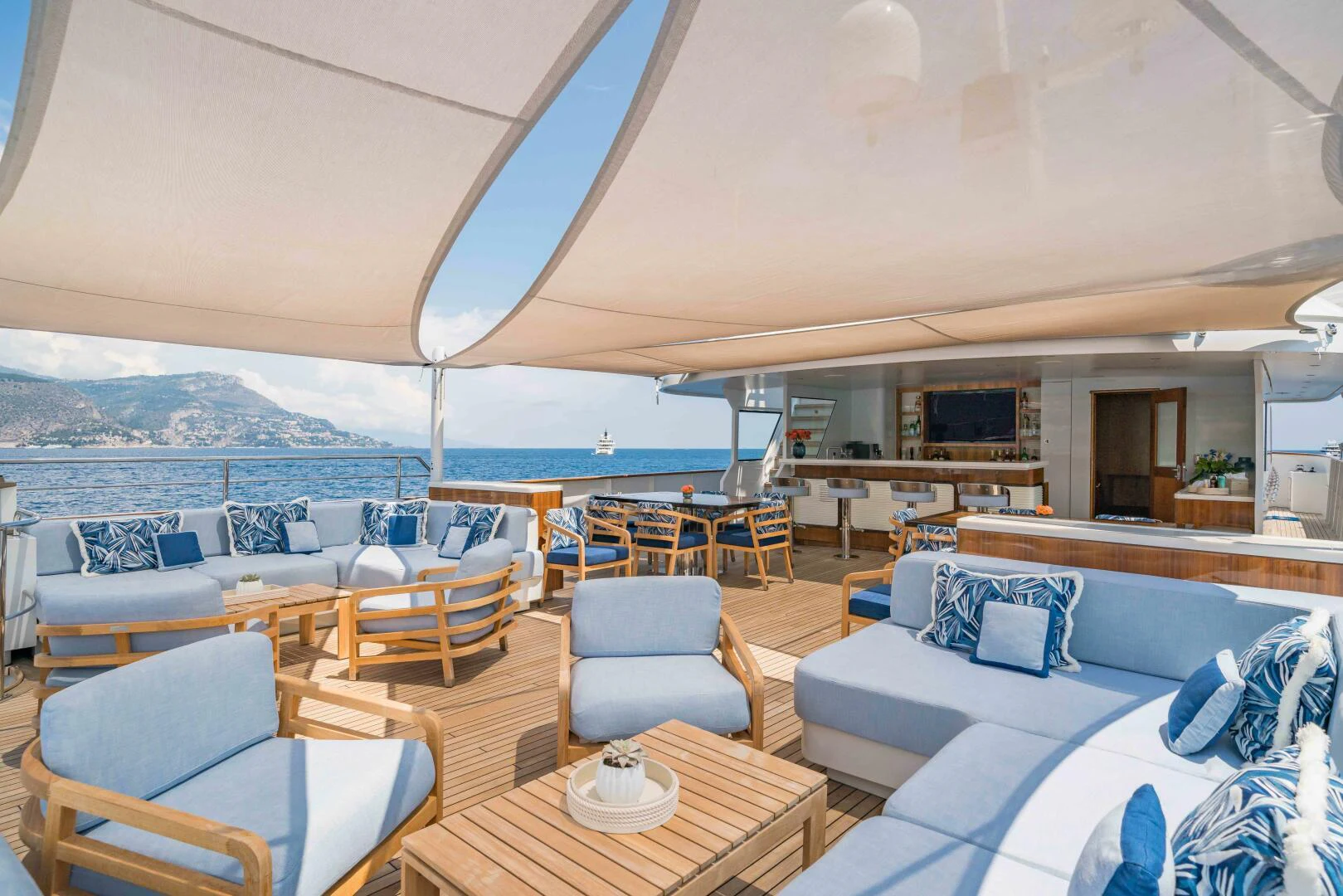a large living room with a large patio and a large body of water aboard SYNTHESIS 66 Yacht for Sale