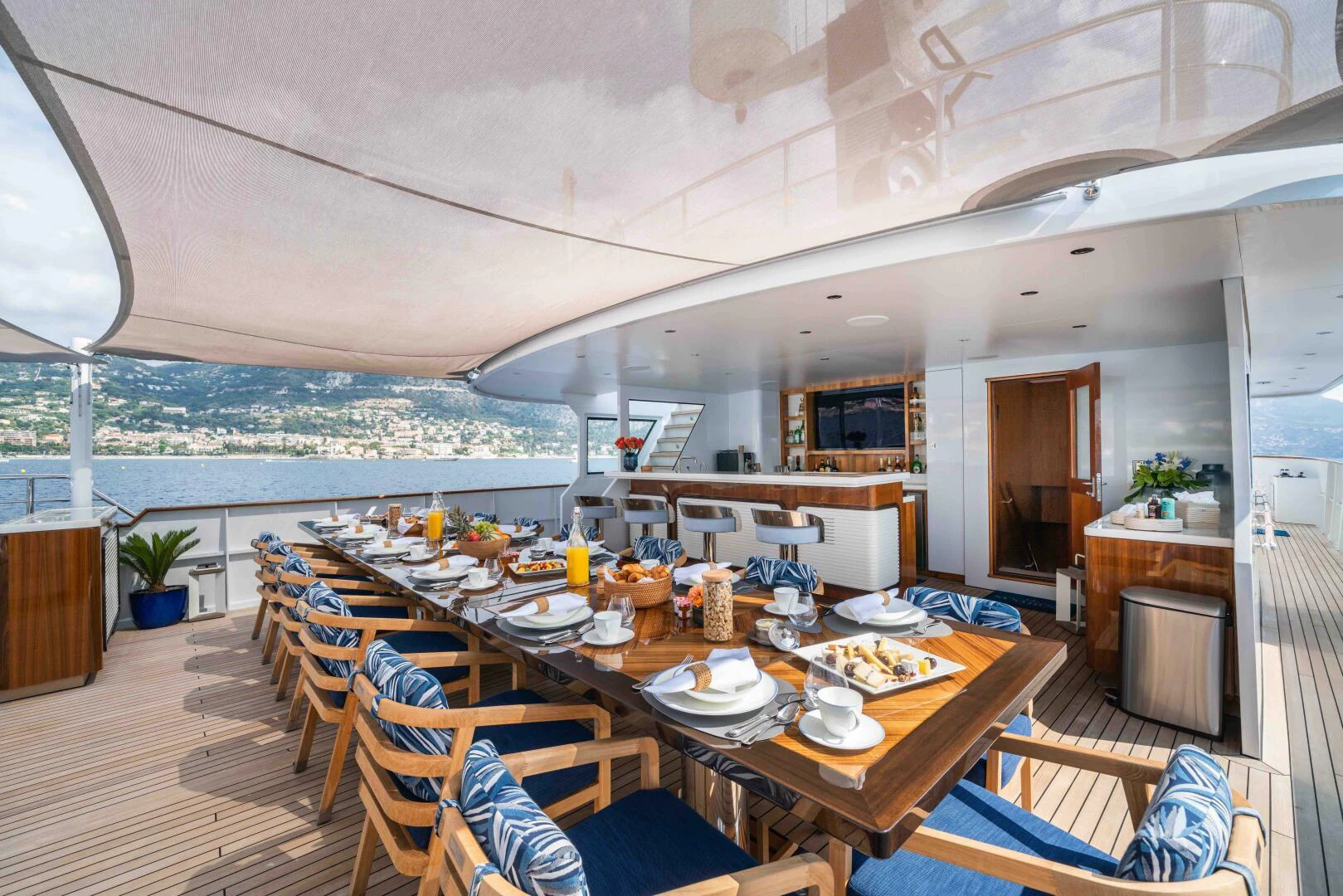 a large dining table on a deck aboard SYNTHESIS 66 Yacht for Sale