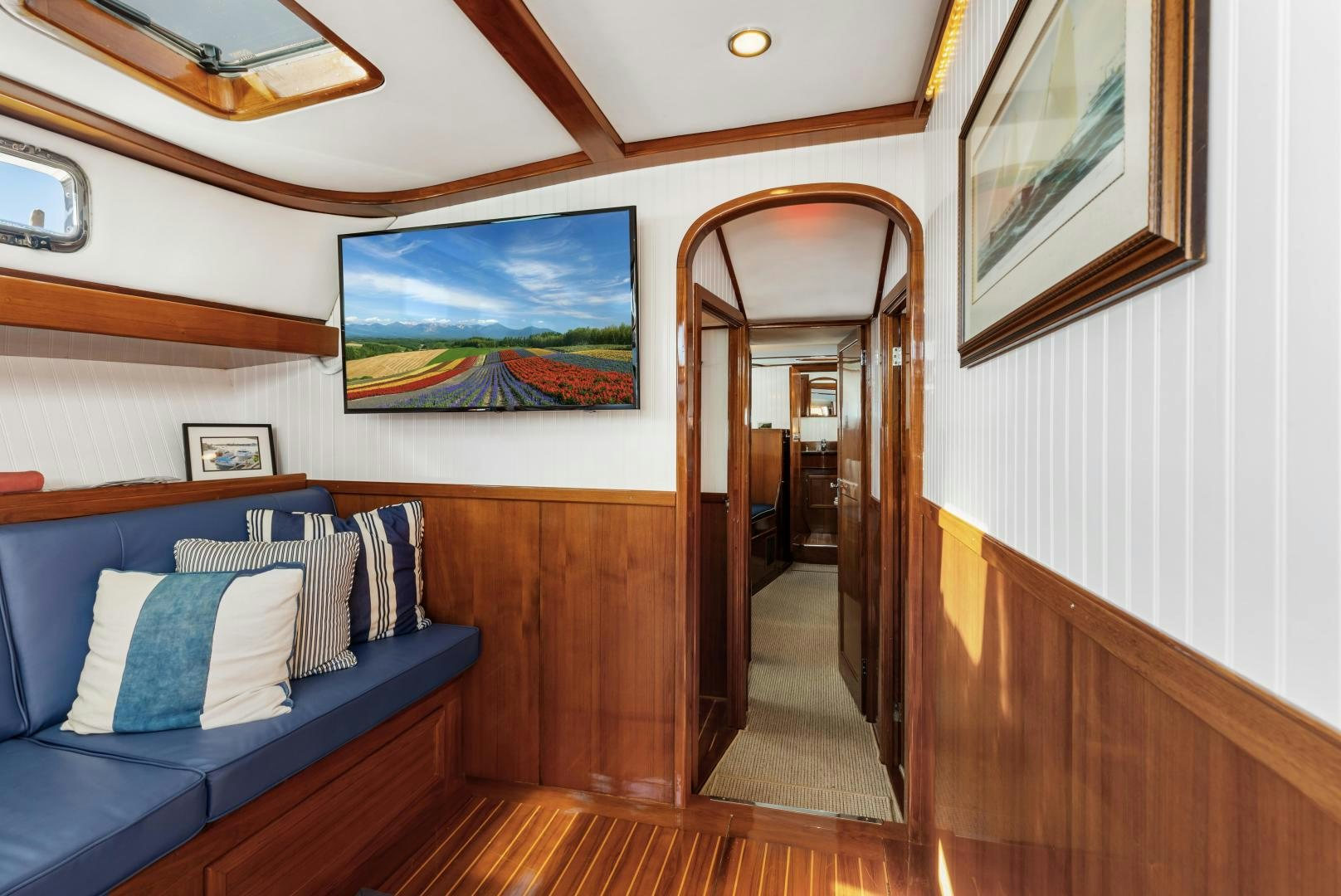 a bedroom with a bed and a mirror aboard SILVER OAK Yacht for Sale