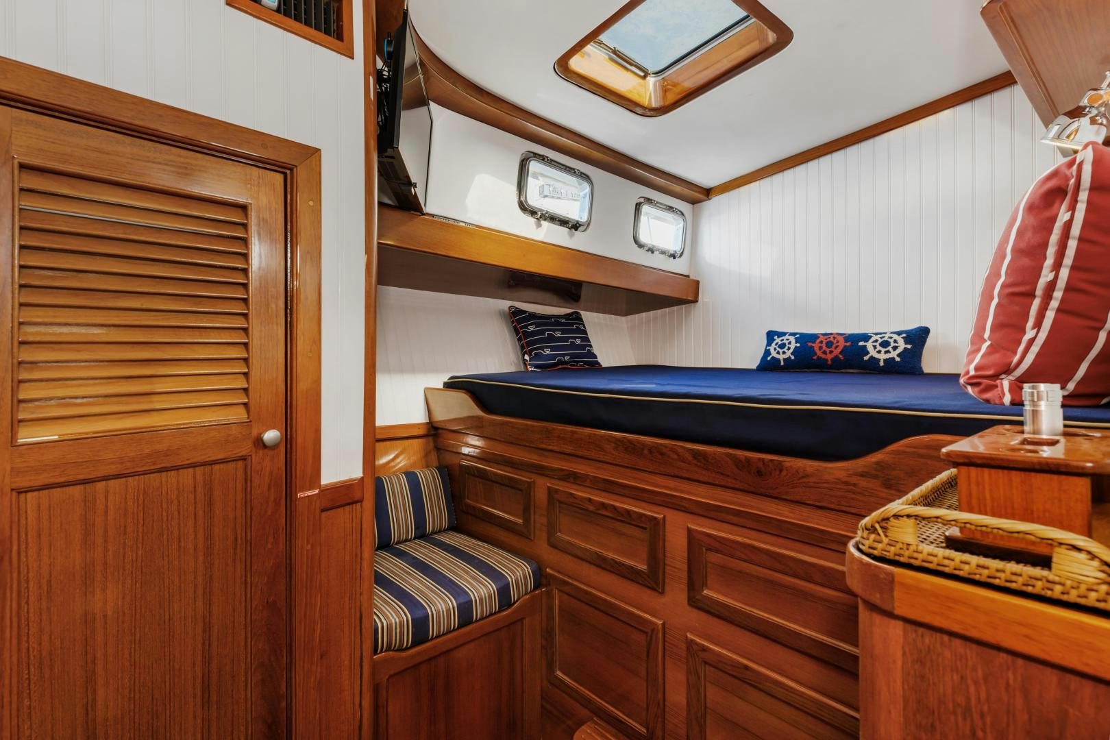 a bedroom with a bed and a desk aboard SILVER OAK Yacht for Sale