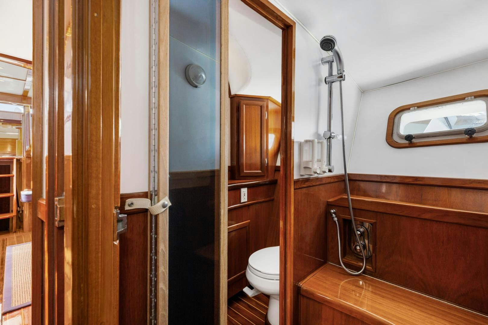 a bathroom with a wood door aboard SILVER OAK Yacht for Sale