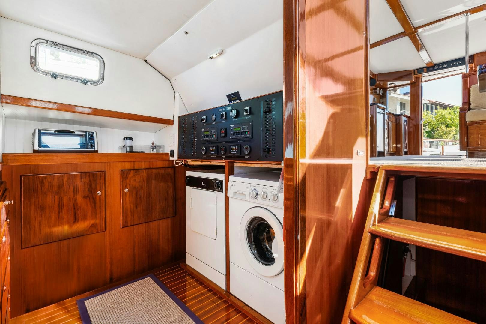 a room with a washing machine and a microwave aboard SILVER OAK Yacht for Sale