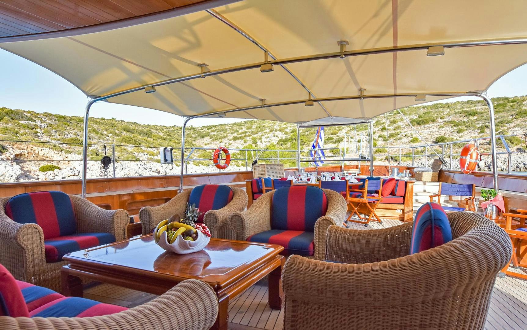 a tent with a table and chairs aboard TAMARITA Yacht for Sale