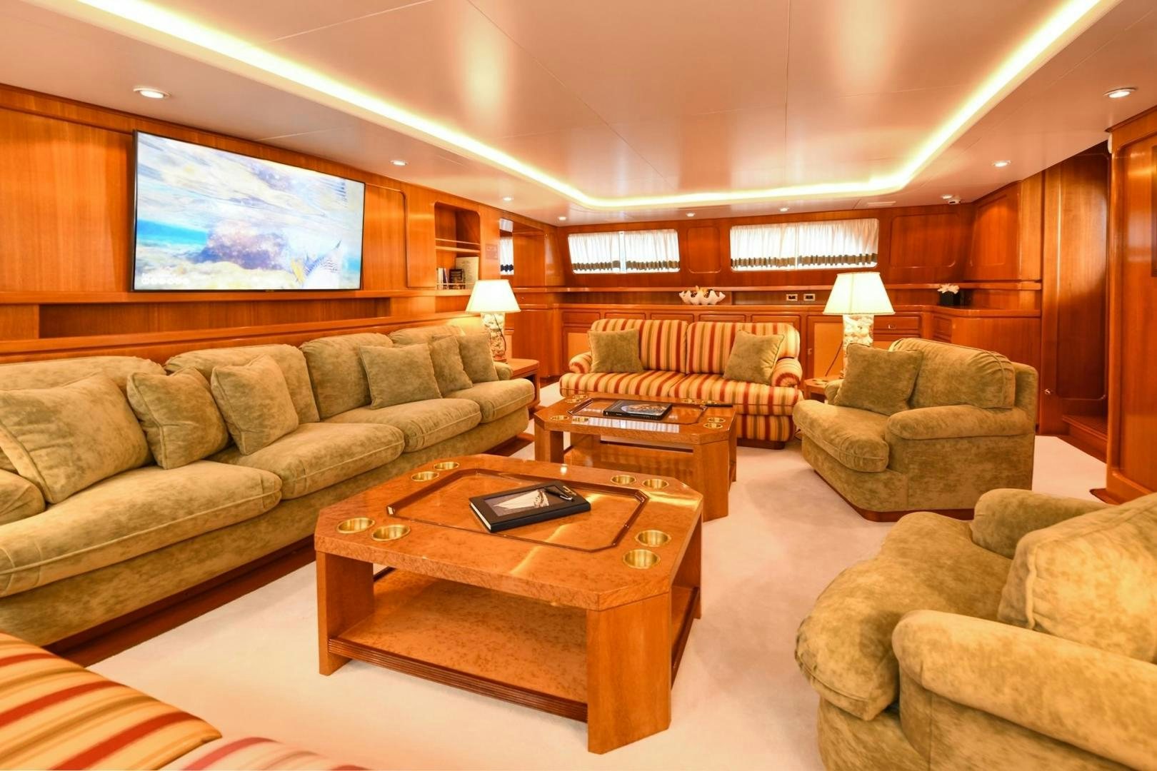 a living room with a couch and a coffee table aboard TAMARITA Yacht for Sale