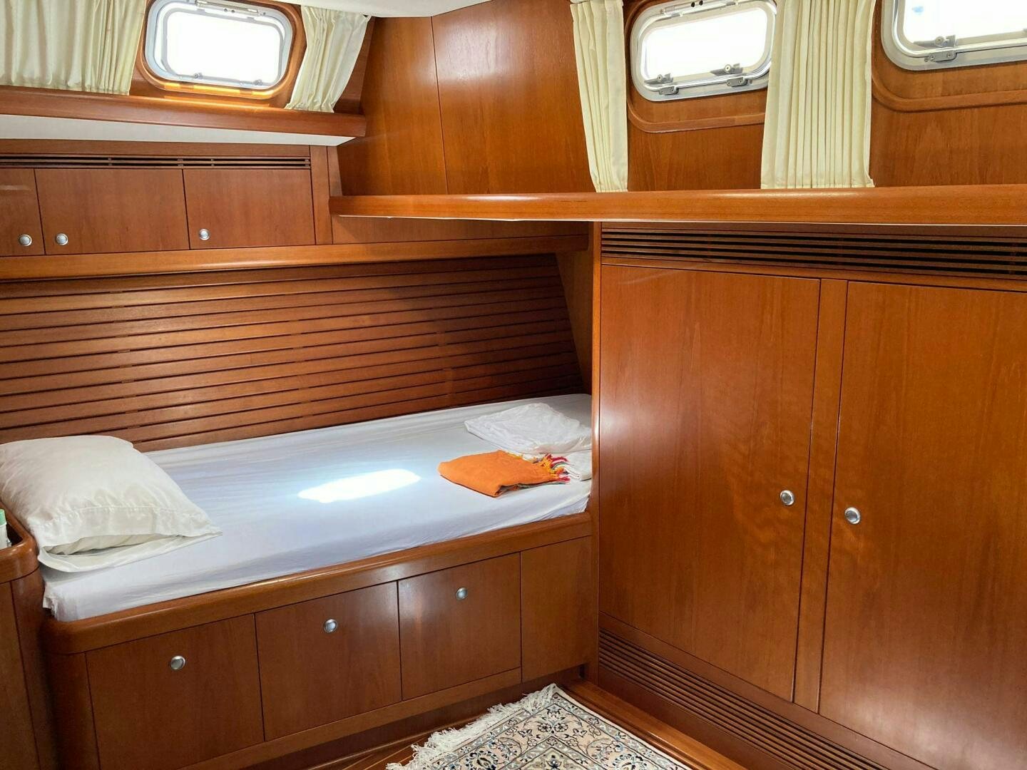 a room with a bed and a window aboard INDIGO VII Yacht for Sale