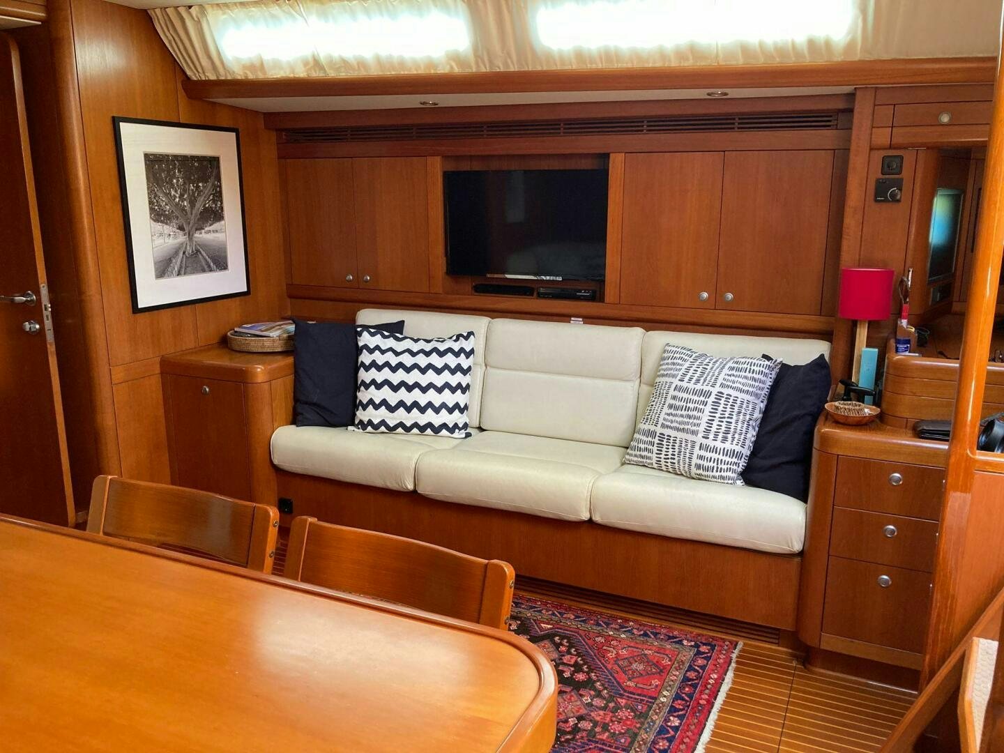 a living room with a couch and a table aboard INDIGO VII Yacht for Sale