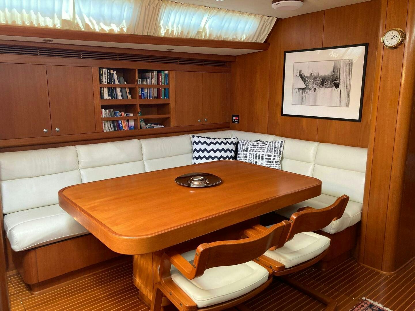 a table and chairs in a room aboard INDIGO VII Yacht for Sale