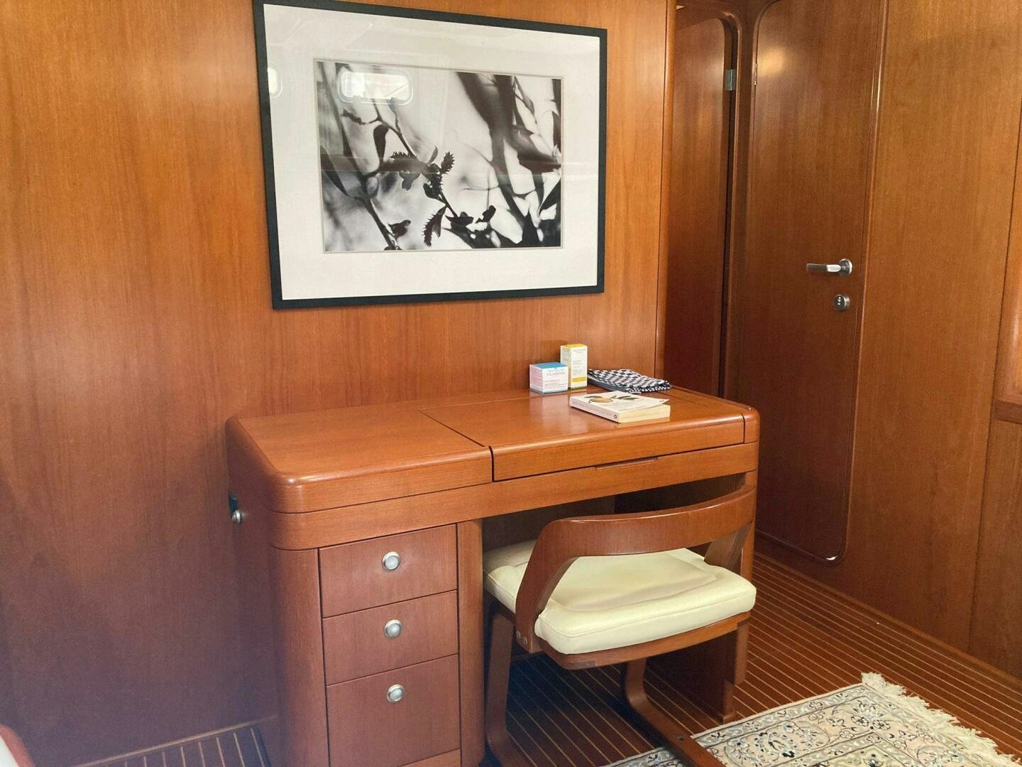 a desk with a painting on it aboard INDIGO VII Yacht for Sale