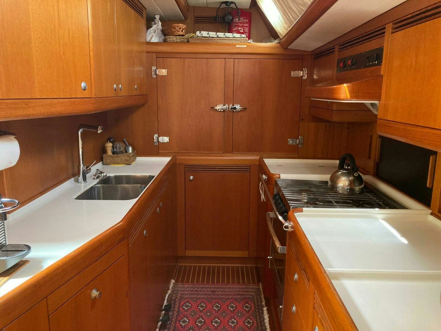 a kitchen with wooden cabinets aboard INDIGO VII Yacht for Sale