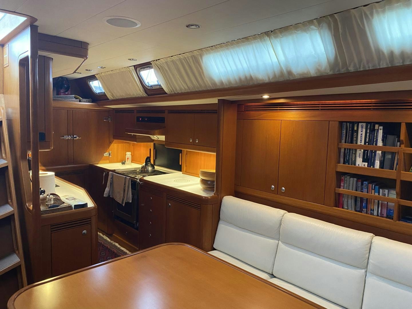 a kitchen with a couch and a table aboard INDIGO VII Yacht for Sale