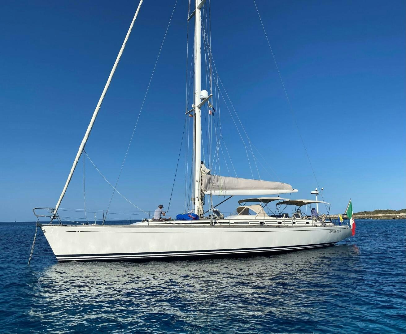 a white boat on the water aboard INDIGO VII Yacht for Sale