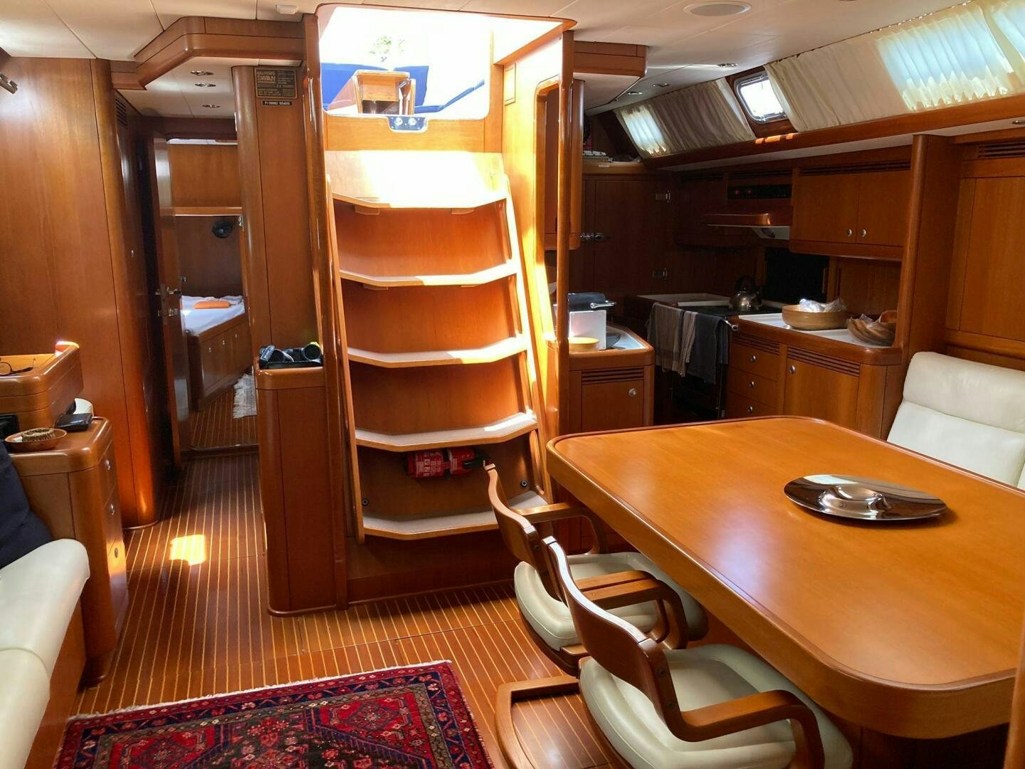 a room with a table and chairs aboard INDIGO VII Yacht for Sale