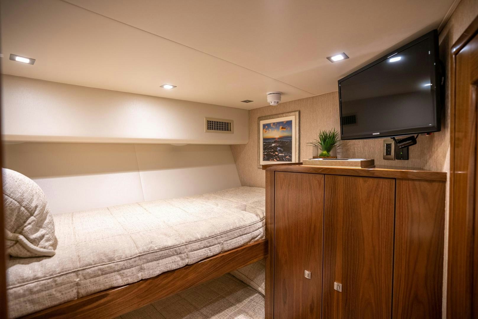 a bedroom with a bed and tv aboard Leslie Ann Yacht for Sale