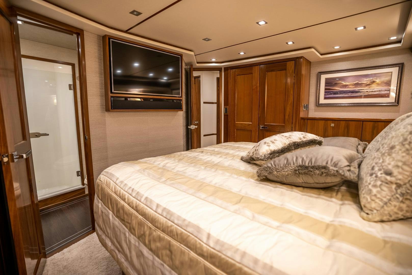 a bedroom with a bed and television aboard Leslie Ann Yacht for Sale