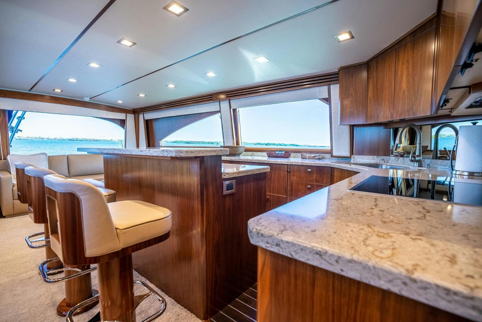 a kitchen with a bar and stools aboard Leslie Ann Yacht for Sale