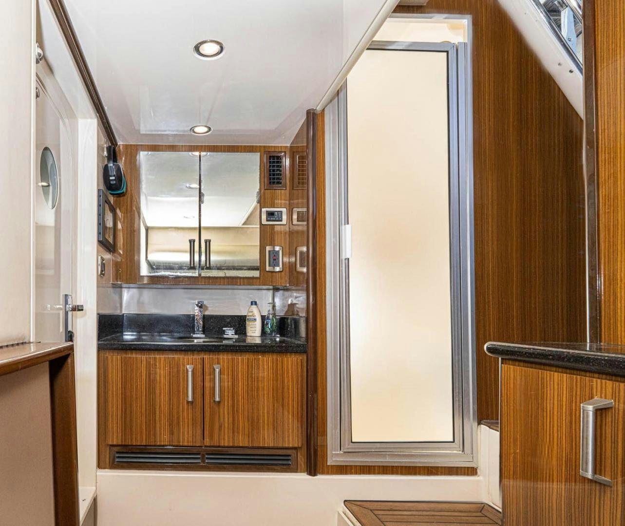 a kitchen with wooden cabinets aboard AWAKEN Yacht for Sale
