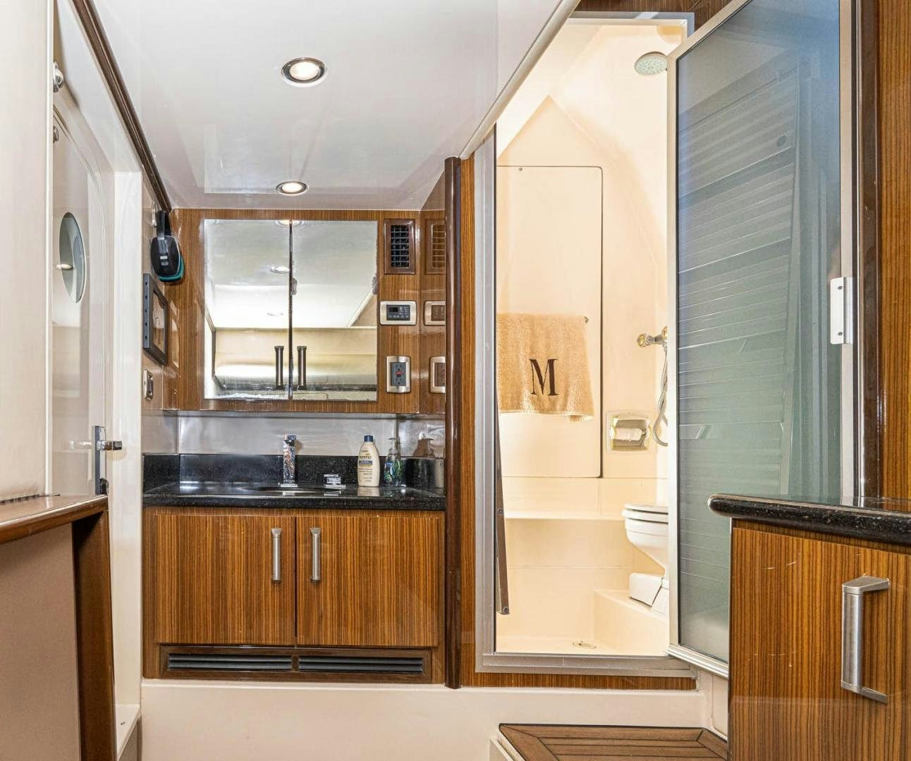 a bathroom with a glass shower aboard AWAKEN Yacht for Sale