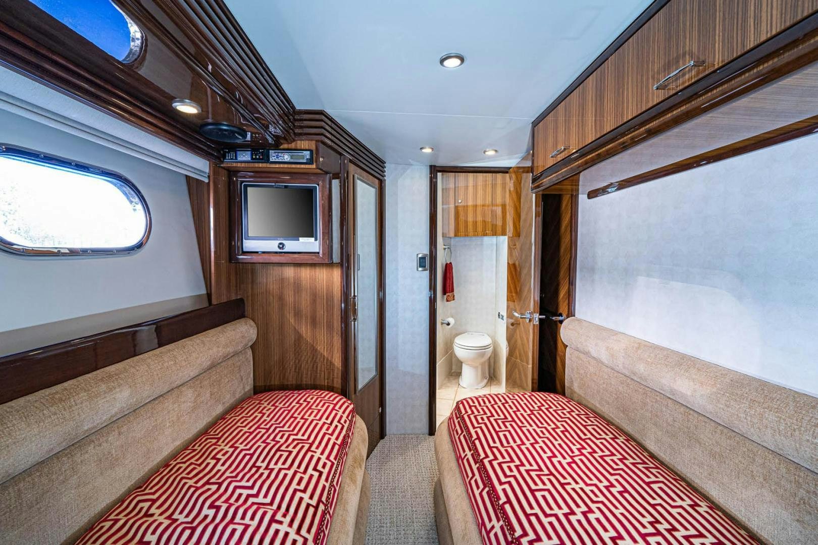 a cabin with a bed and a television aboard AWAKEN Yacht for Sale