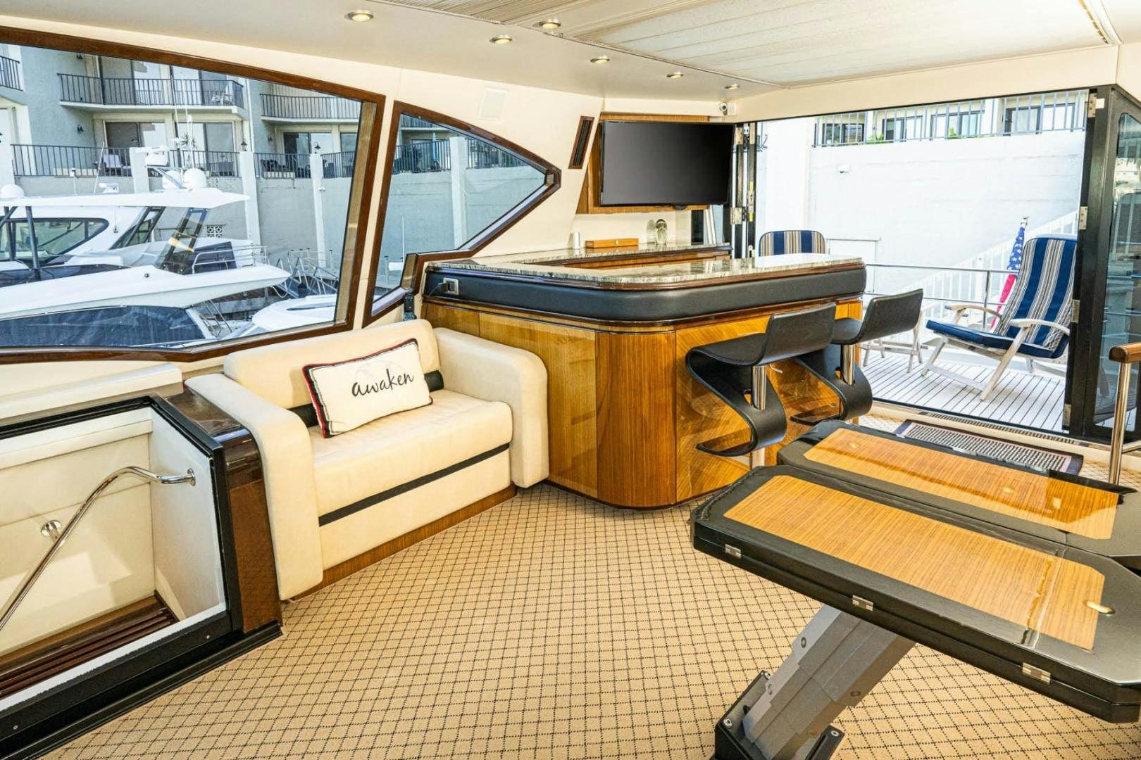 a room with a table and couch aboard AWAKEN Yacht for Sale