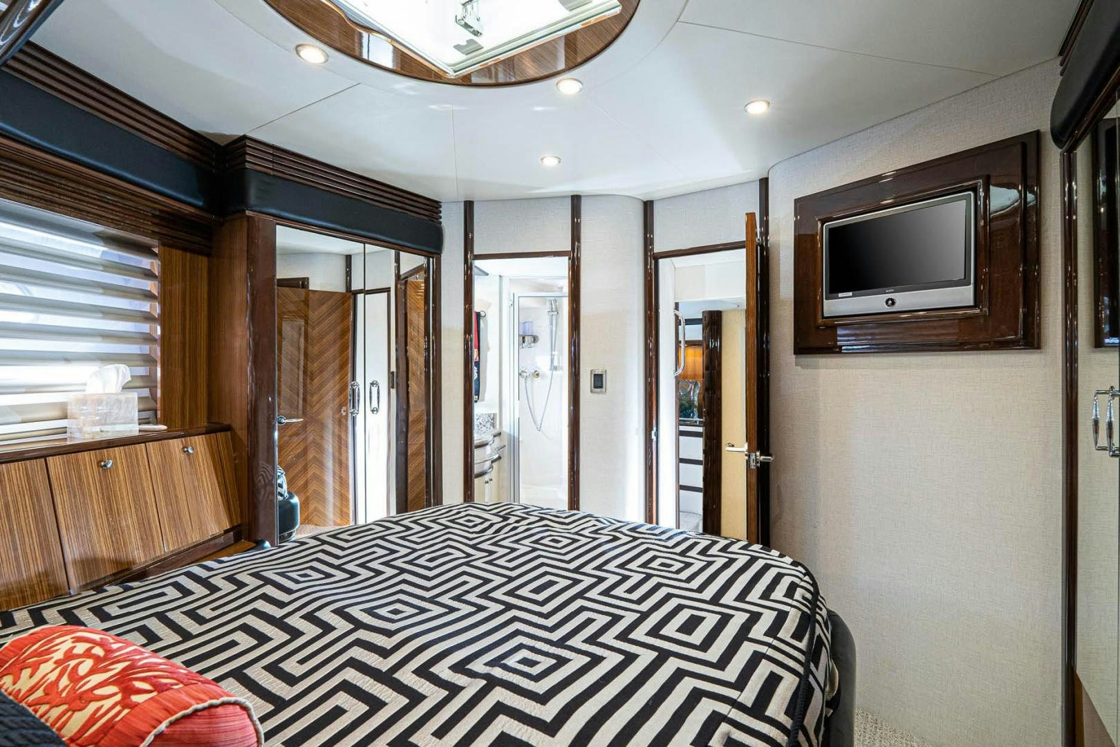 a bedroom with a bed and a tv aboard AWAKEN Yacht for Sale