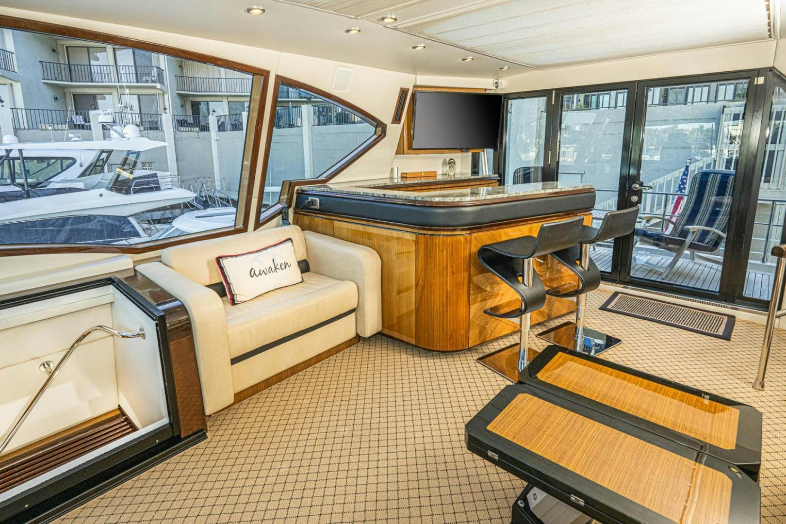 a room with a table and couch aboard AWAKEN Yacht for Sale