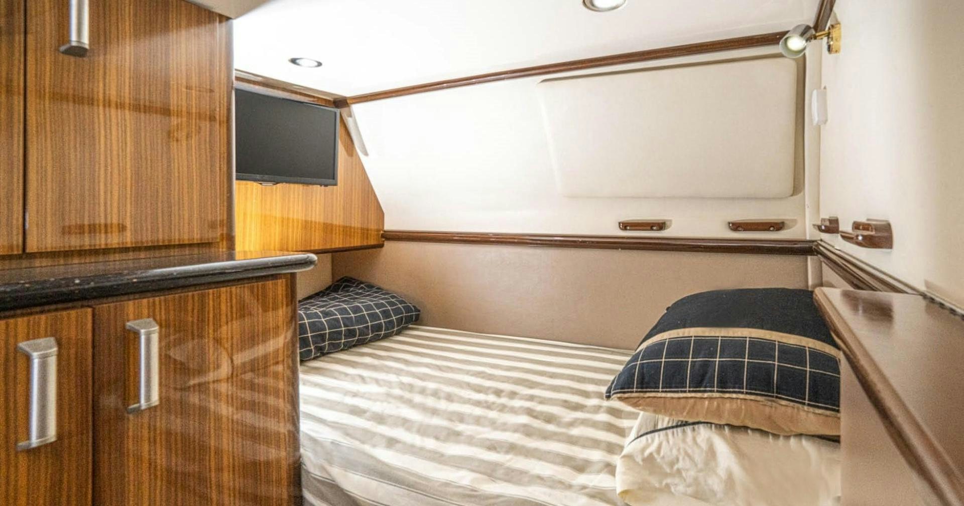 a bed with a white sheet aboard AWAKEN Yacht for Sale