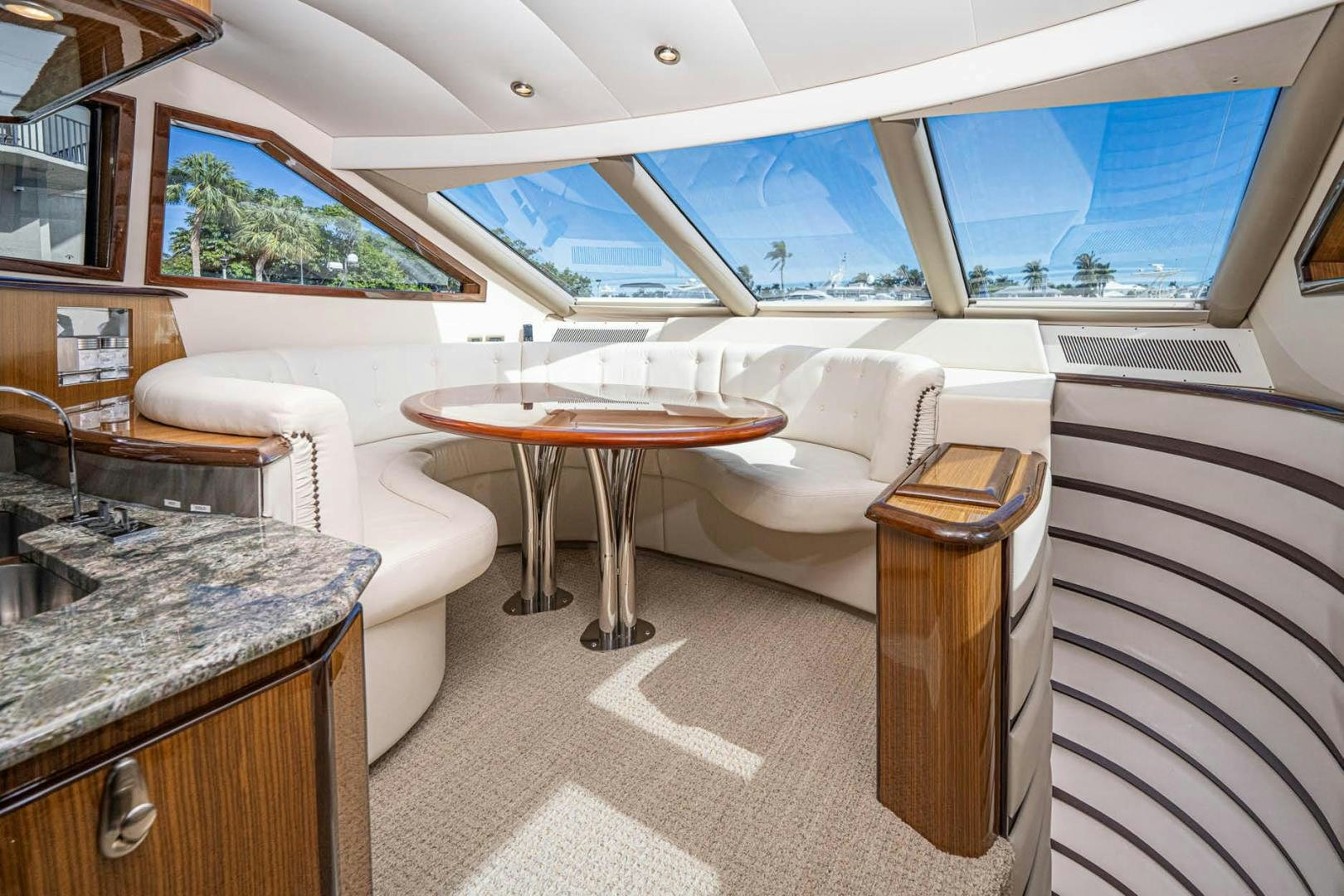 a room with a table and chairs aboard AWAKEN Yacht for Sale