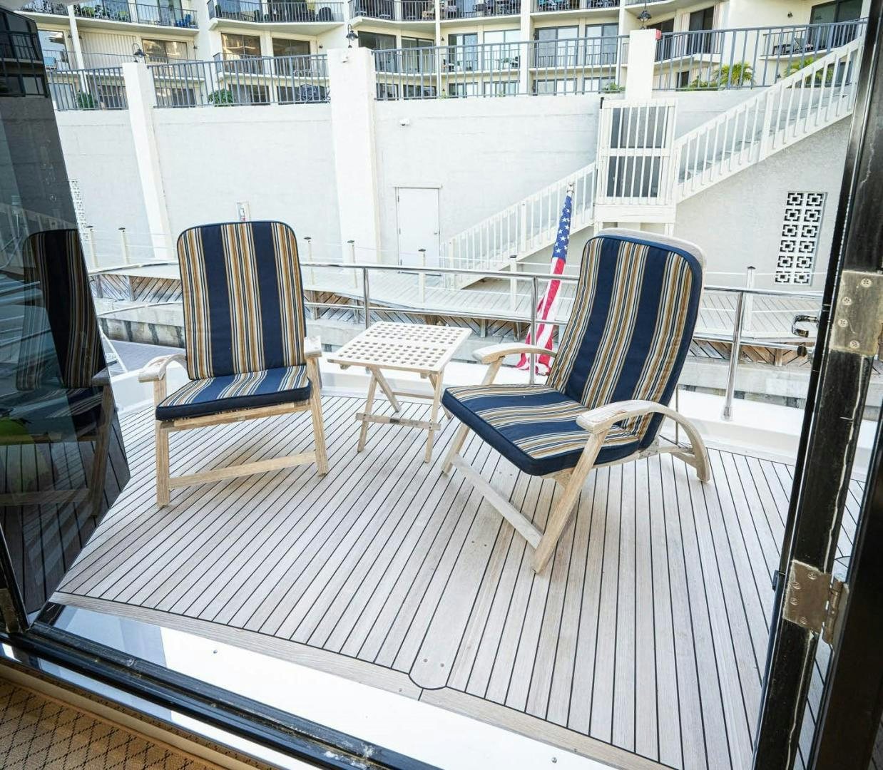 chairs on a balcony aboard AWAKEN Yacht for Sale