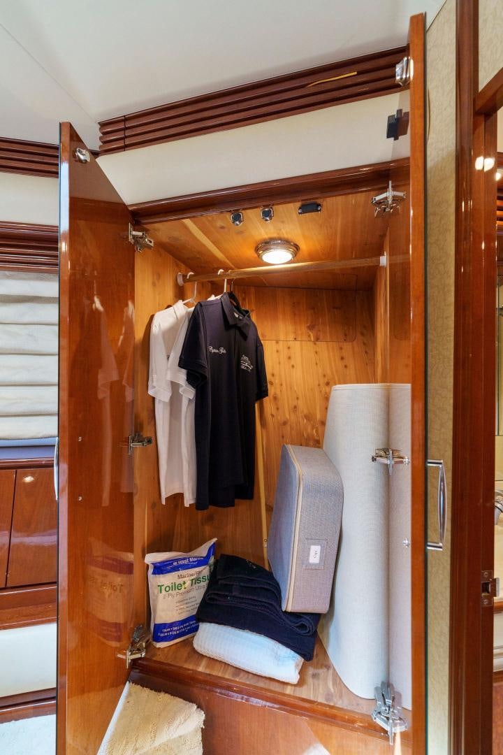 a closet with clothes and toiletries aboard LA BELLA VITA Yacht for Sale