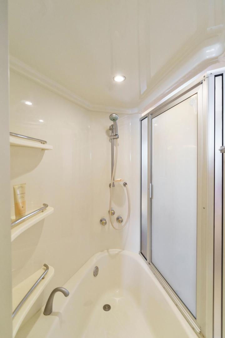 a bathroom with a bathtub and shower aboard LA BELLA VITA Yacht for Sale