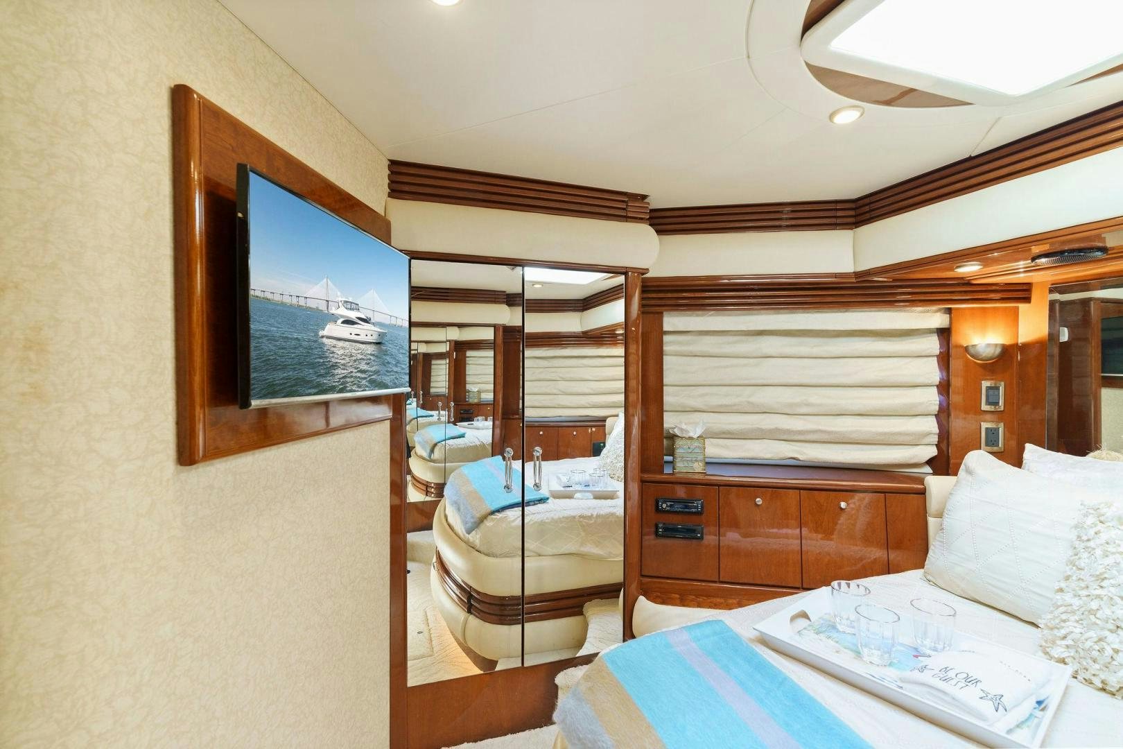 a bedroom with a television and a bed aboard LA BELLA VITA Yacht for Sale
