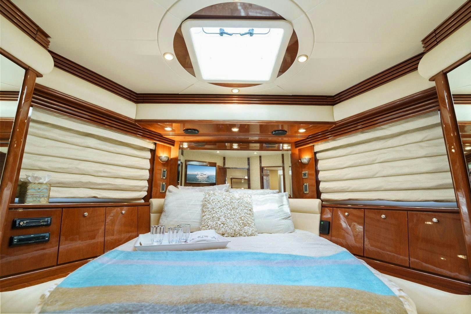 a bedroom with a bed and a wood wall aboard LA BELLA VITA Yacht for Sale
