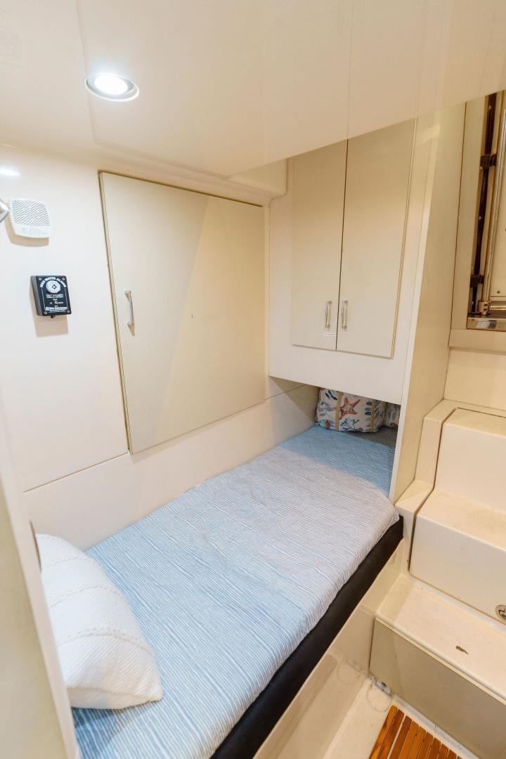 a small bedroom with a bed aboard LA BELLA VITA Yacht for Sale