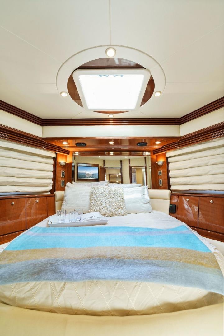 a bed with a blue comforter aboard LA BELLA VITA Yacht for Sale