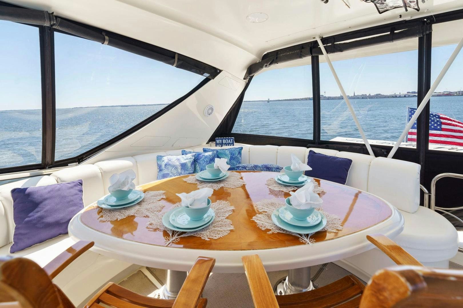 a table with plates and cups on it aboard LA BELLA VITA Yacht for Sale
