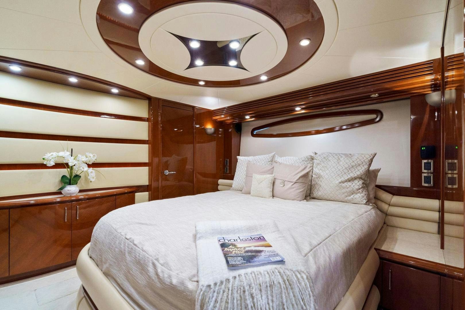 a bed with a white bed spread aboard LA BELLA VITA Yacht for Sale