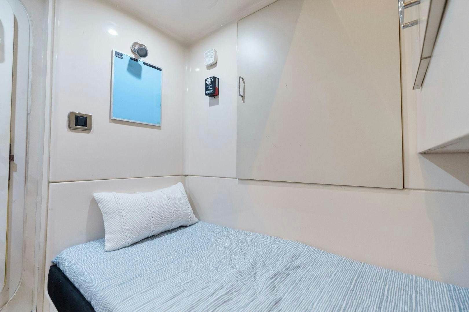 a bed with a blue sheet aboard LA BELLA VITA Yacht for Sale