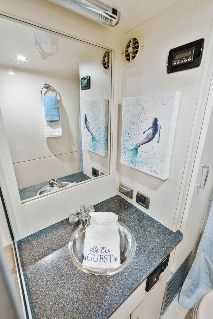 a bathroom with a round mirror aboard LA BELLA VITA Yacht for Sale
