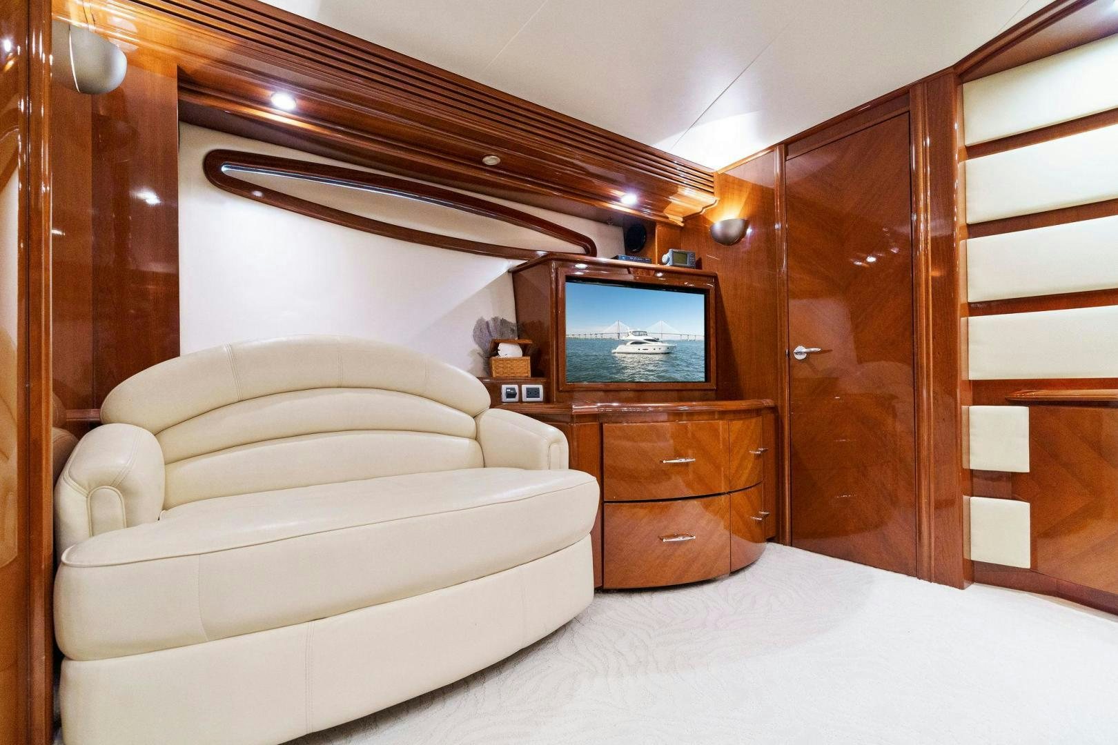 a living room with a bed and a television aboard LA BELLA VITA Yacht for Sale