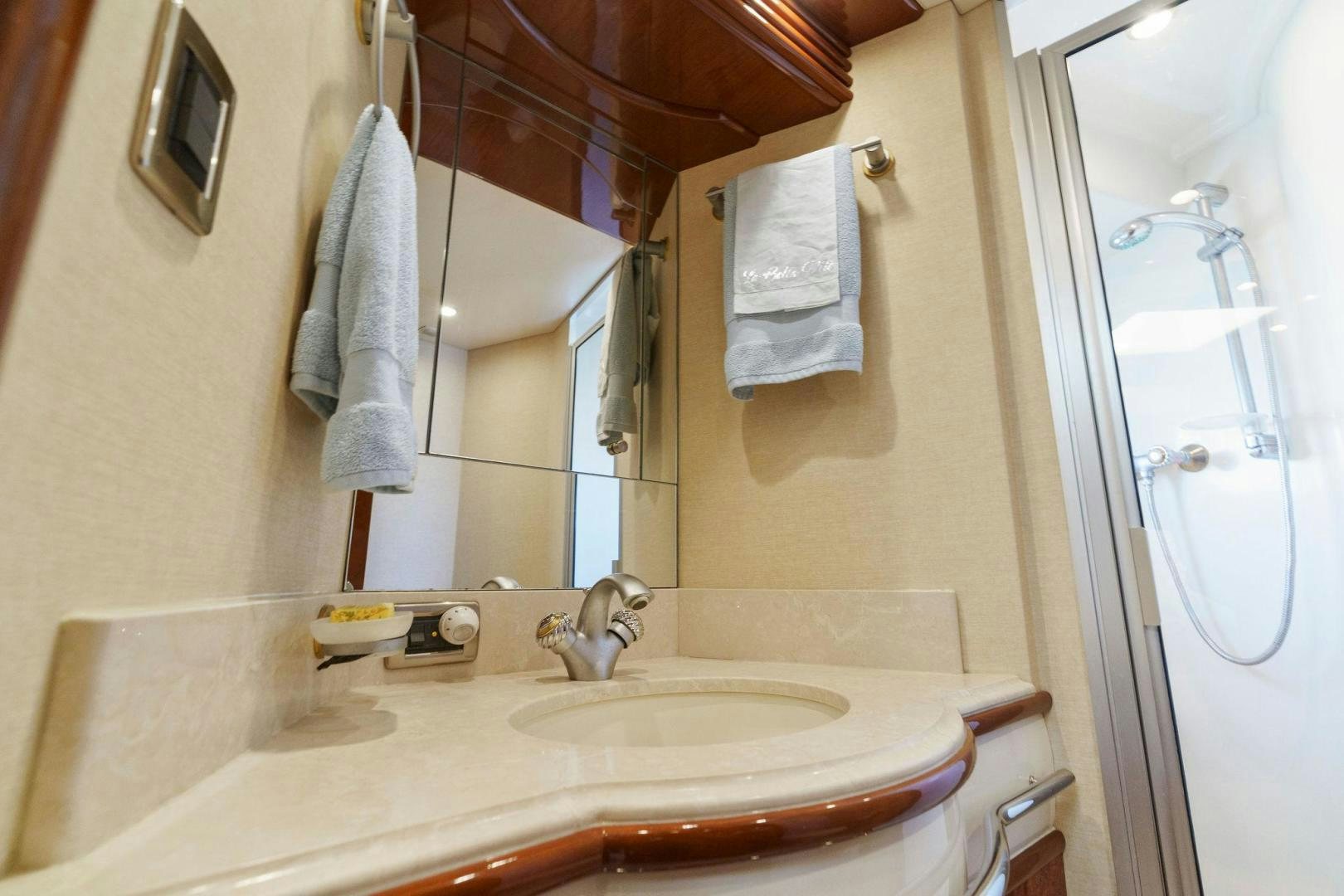 a bathroom with a sink and a mirror aboard LA BELLA VITA Yacht for Sale