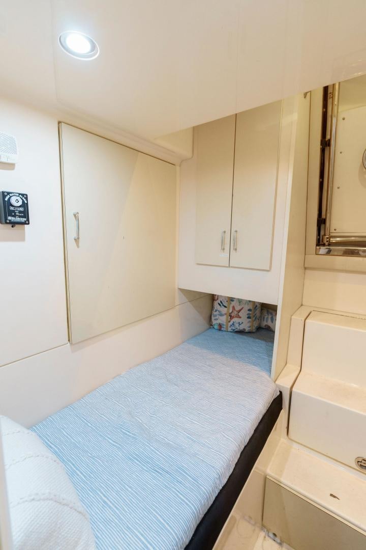 a small room with a bed and cabinets aboard LA BELLA VITA Yacht for Sale