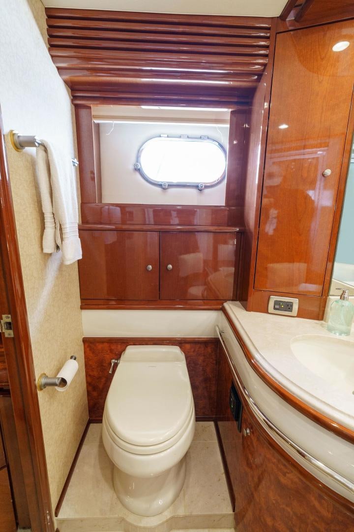 a bathroom with a toilet and sink aboard LA BELLA VITA Yacht for Sale