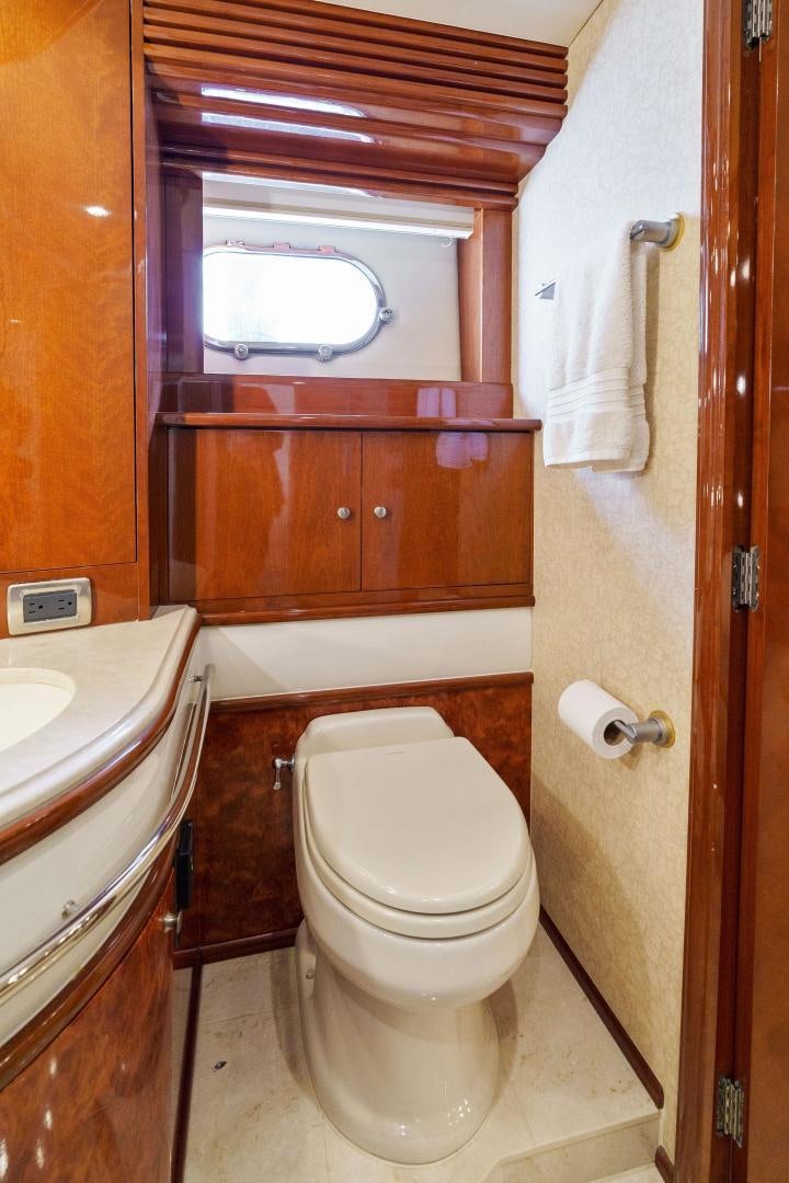 a bathroom with a toilet and a sink aboard LA BELLA VITA Yacht for Sale