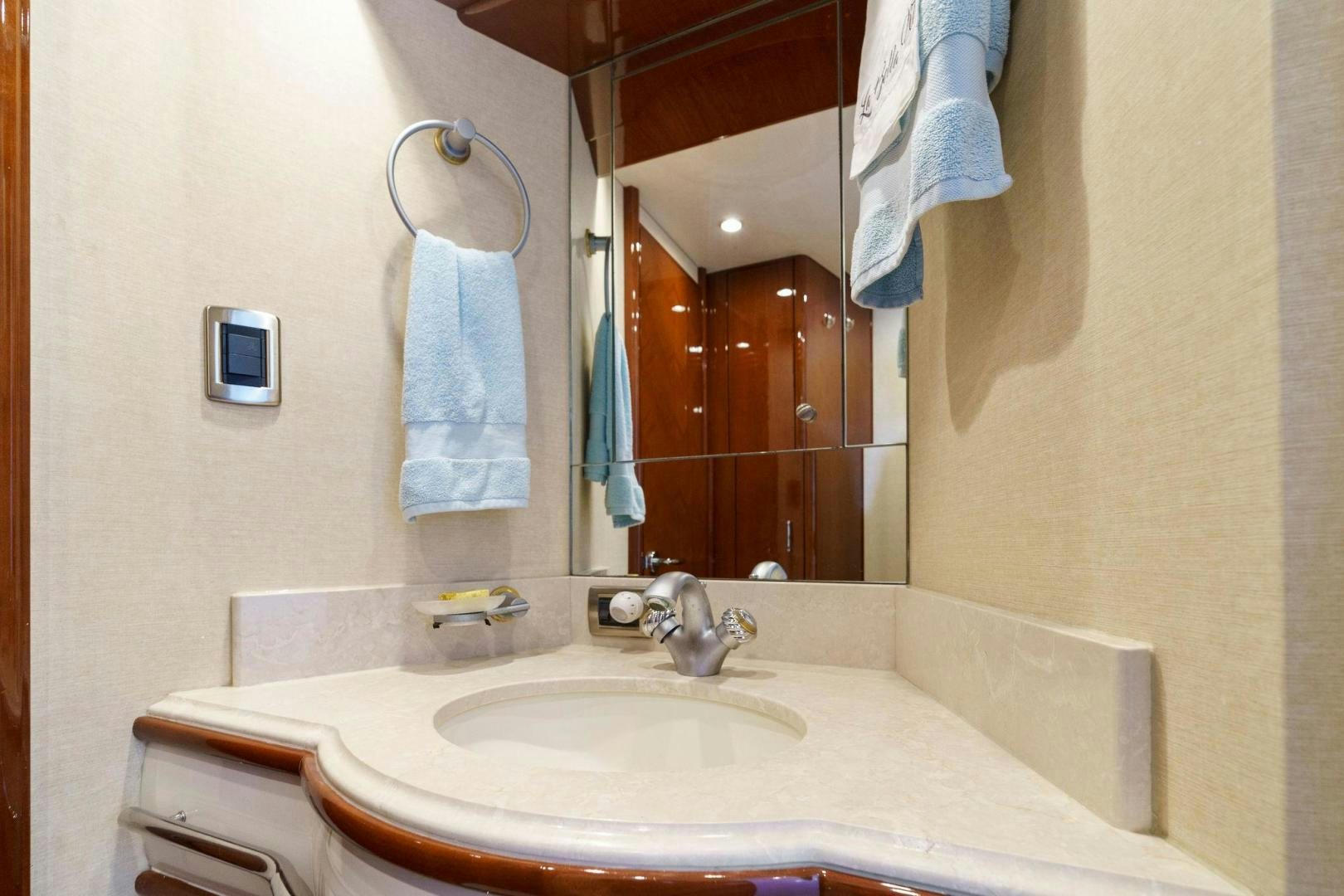 a bathroom with a sink and a mirror aboard LA BELLA VITA Yacht for Sale