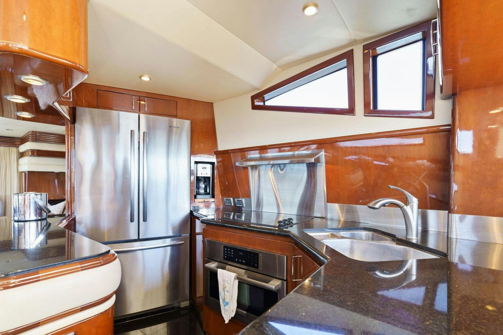 a kitchen with a stainless steel refrigerator aboard LA BELLA VITA Yacht for Sale